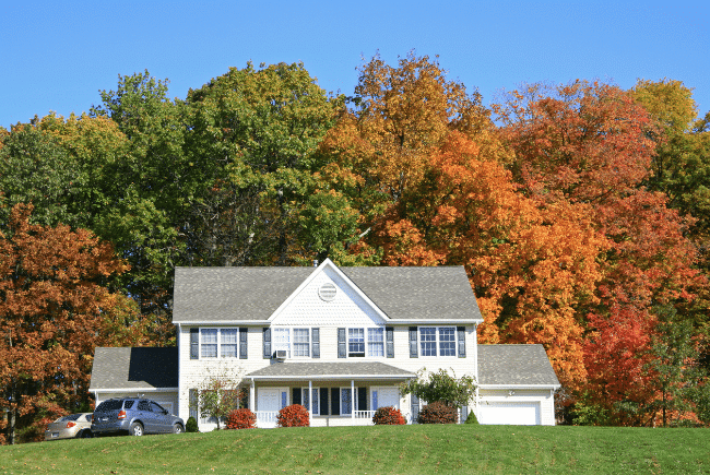 fall_trees_changing_colors_in_front_of_house_lawn